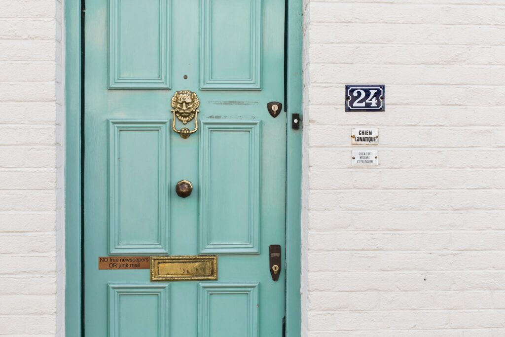wooden door and house number sign