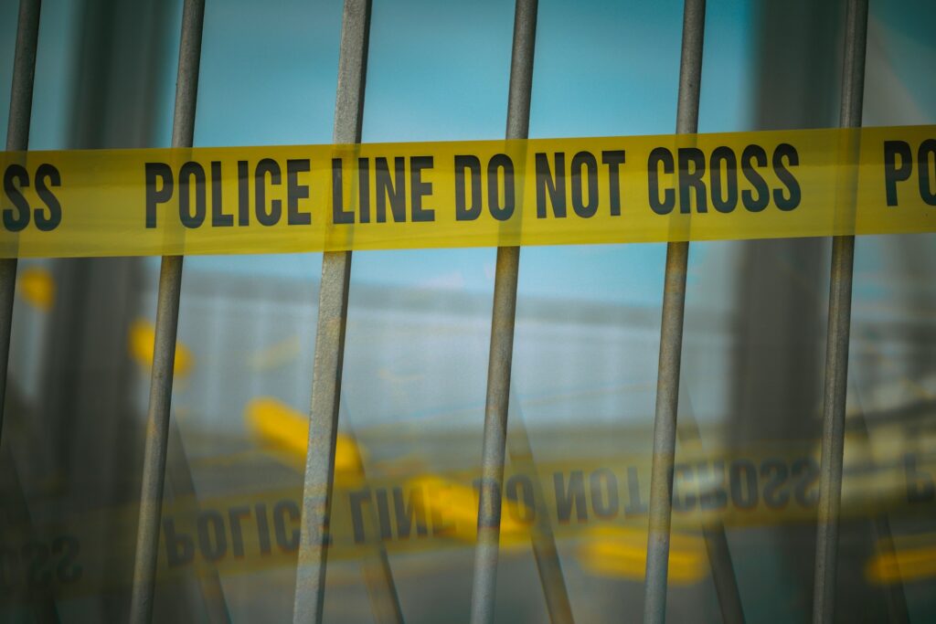 yellow police line behind bars
