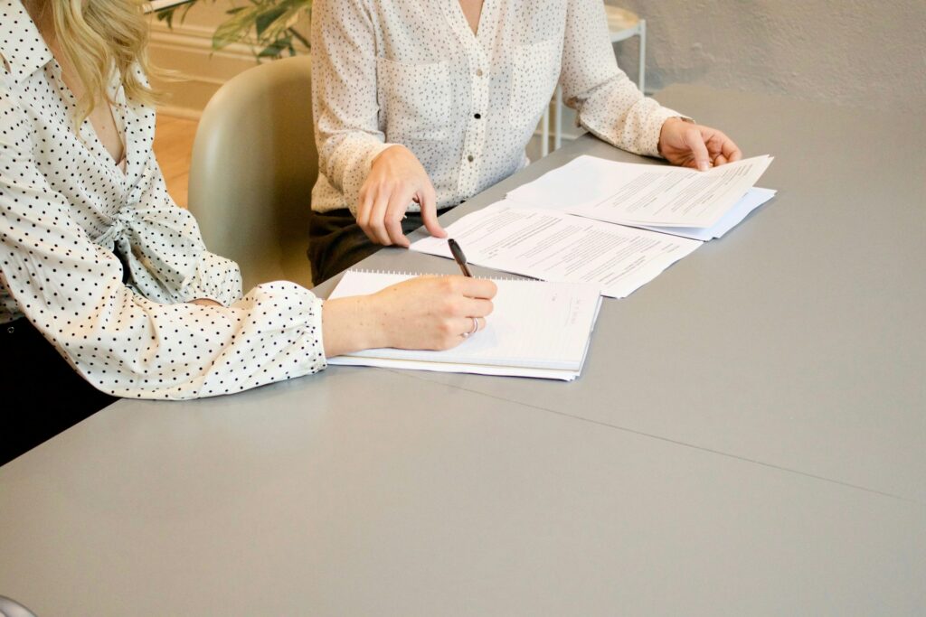 two women working with documents