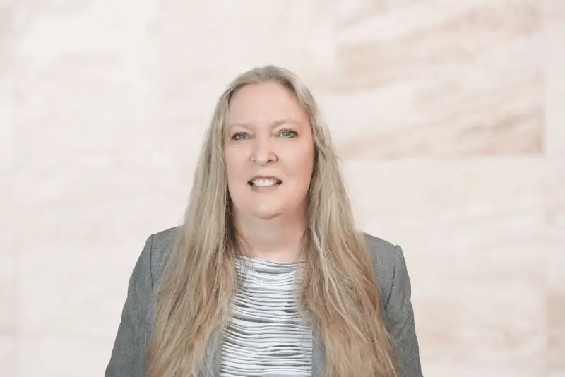 Professional headshot of Houston family law attorney Kiri Martin wearing a grey blazer.