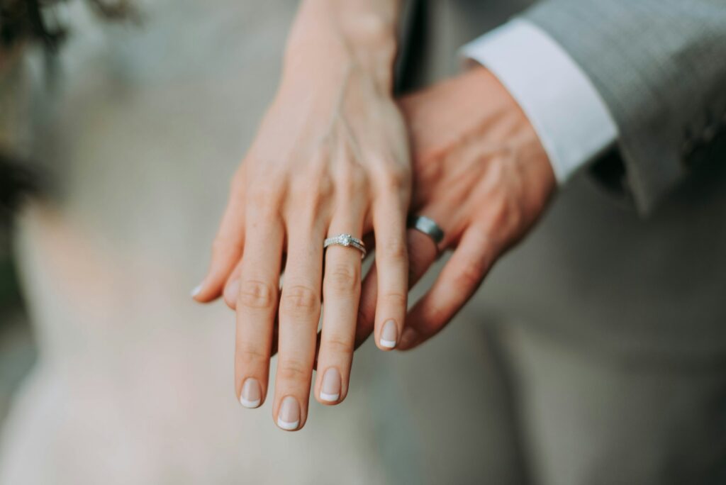 couple showing wedding bands on fingers