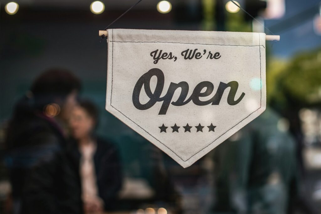 business signs that says "yes, we're open"