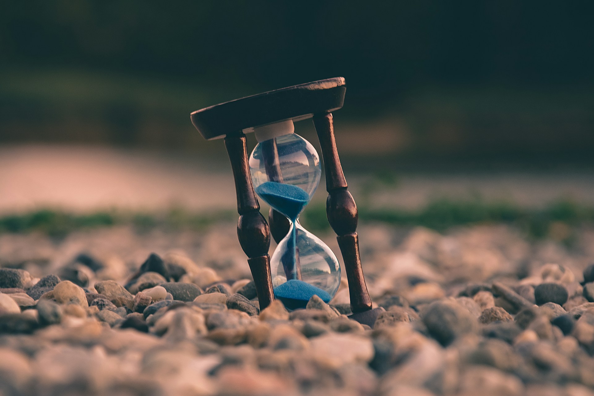 an hourglass on a pile of rocks