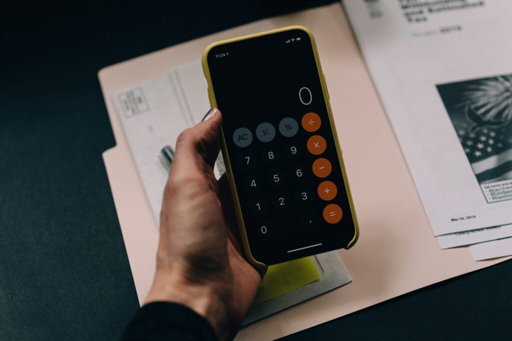 kelly-sikkema-3-Tc_5LROrM-unsplash mobile phone calculator and documents