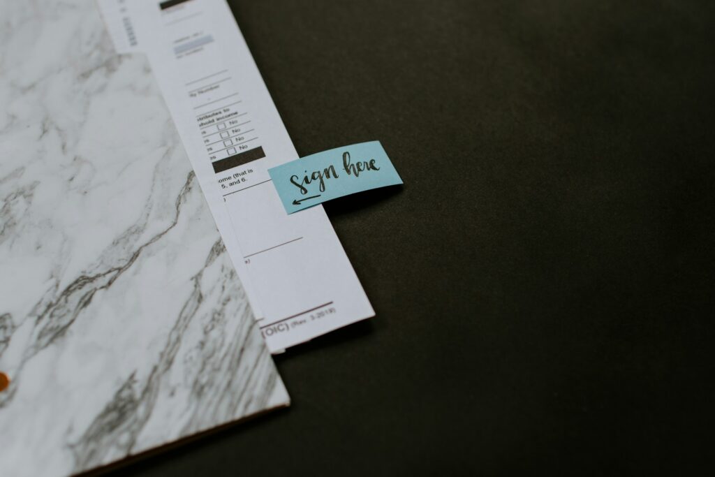 document with a "sign here" note