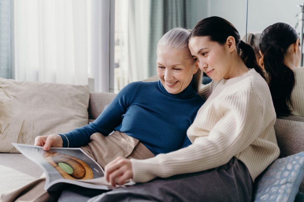 woman with elderly parent reading