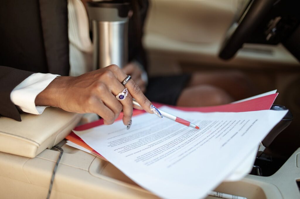 person holding a pen on paper