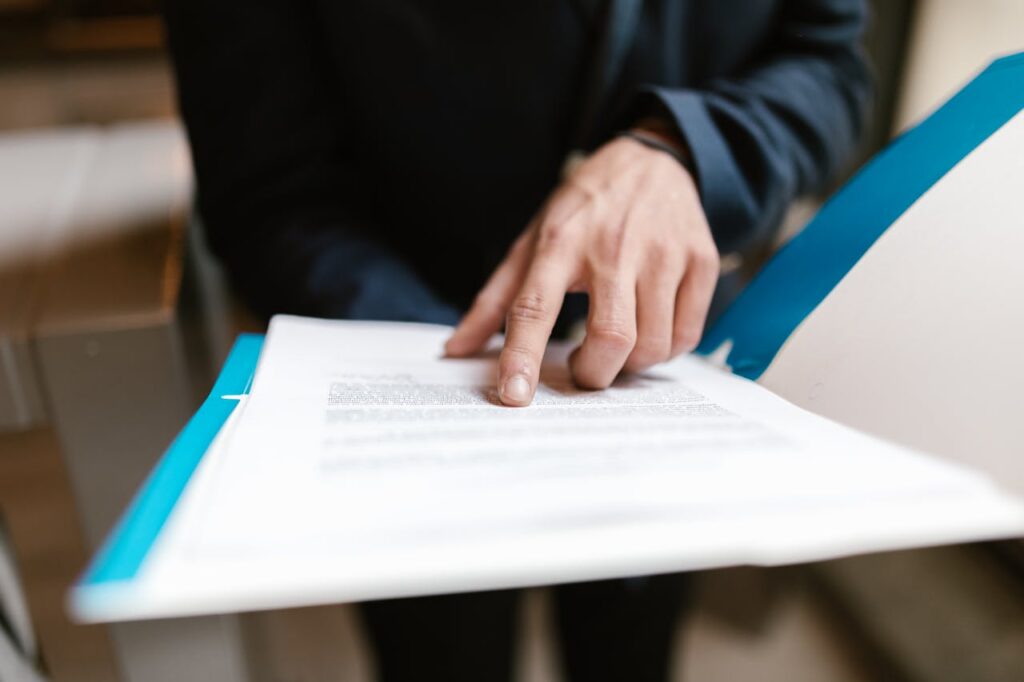person pointing at something on a document