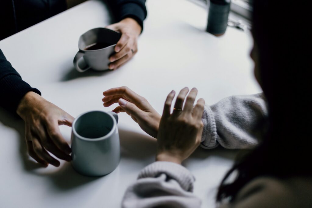 two people talking while having coffee
