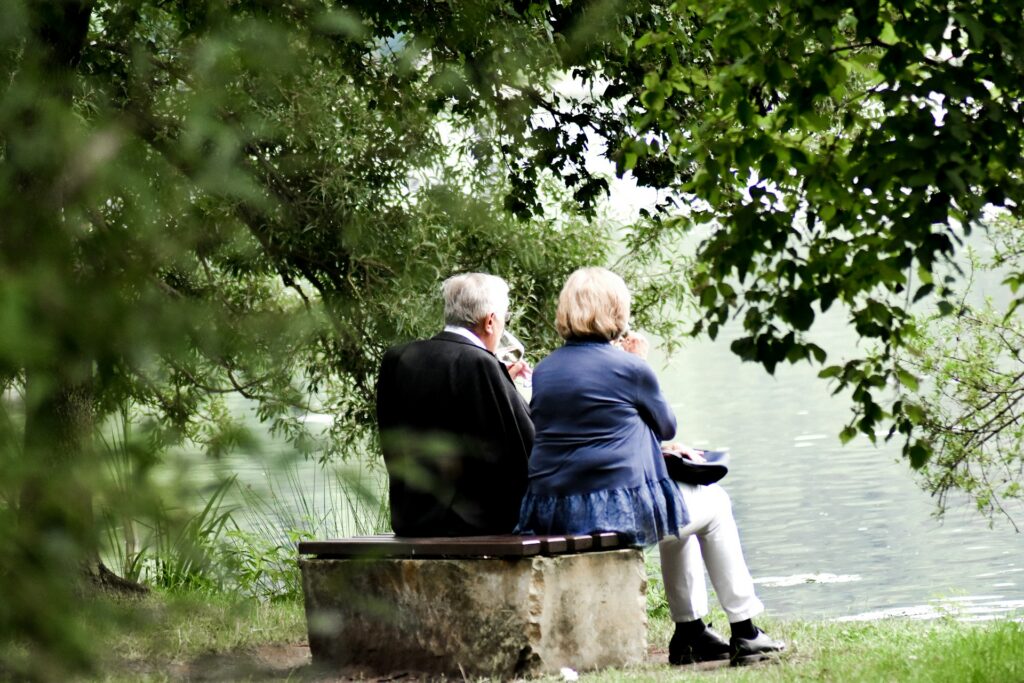 sven-mieke-zlA7c39DfFk-unsplash an elderly couple looking at lake