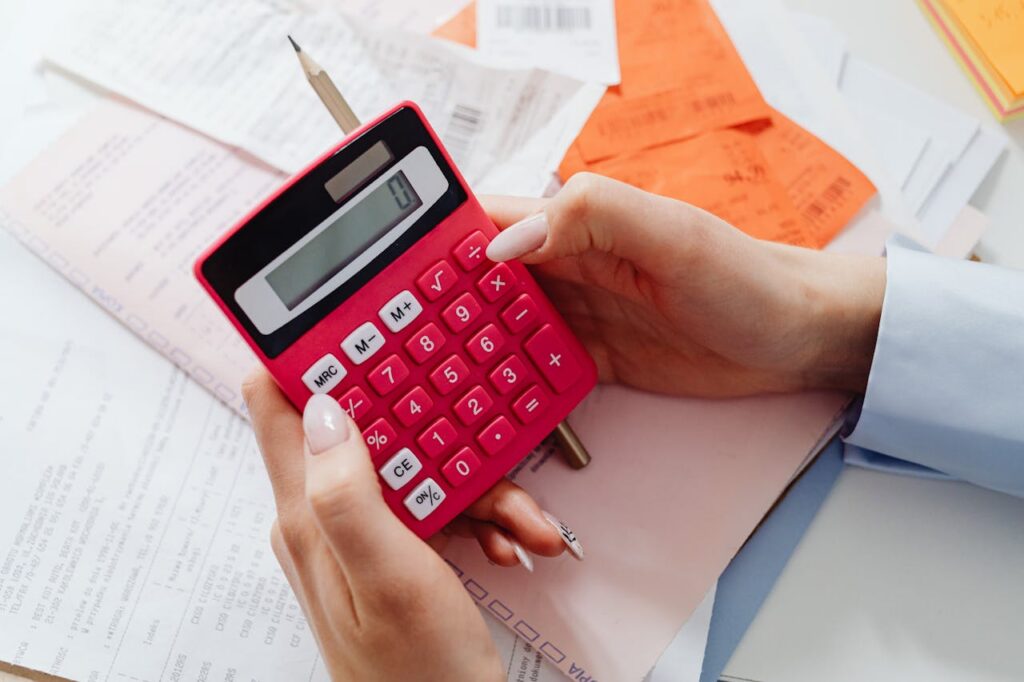 person using a red calculator