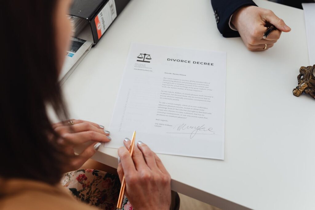 A woman signing a divorce decree