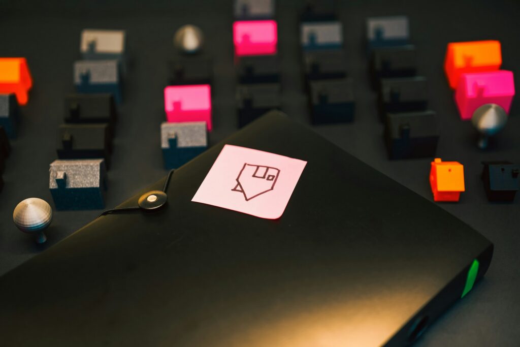 mini plastic houses and a folder with sticky note of house drawing