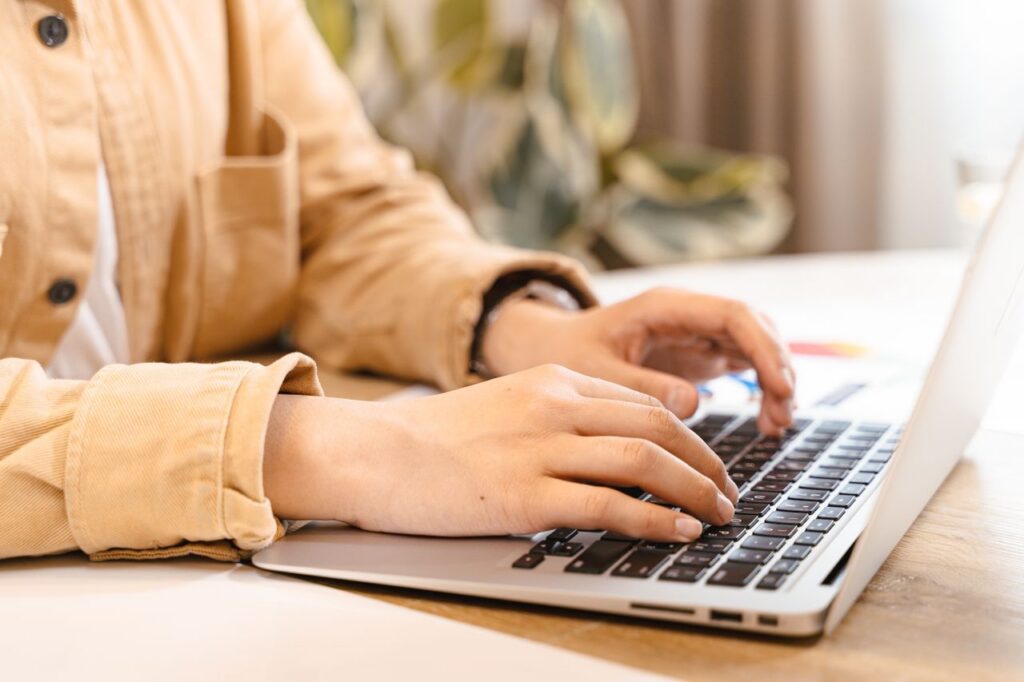 person typing on laptop