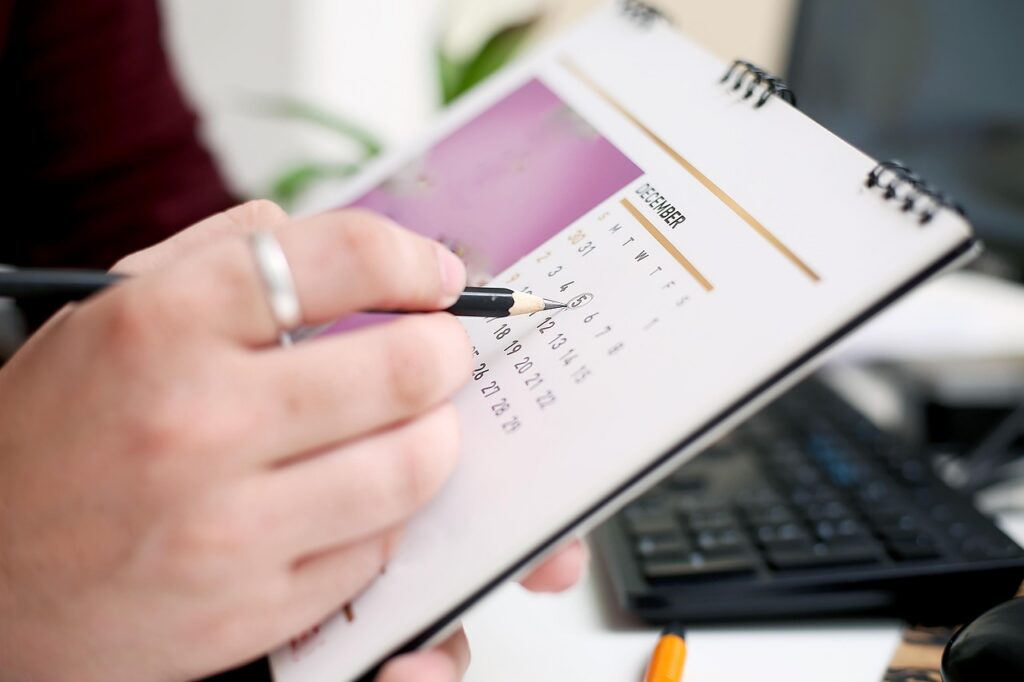 person marking a date on a calendar
