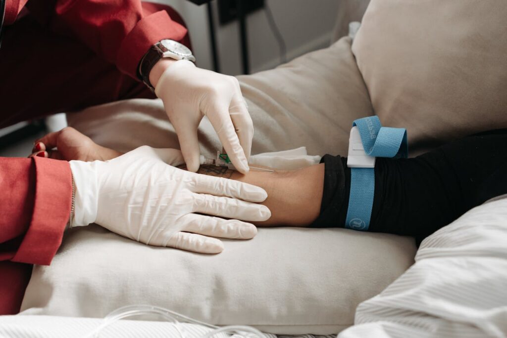 medical professional inserting a needle on a patient