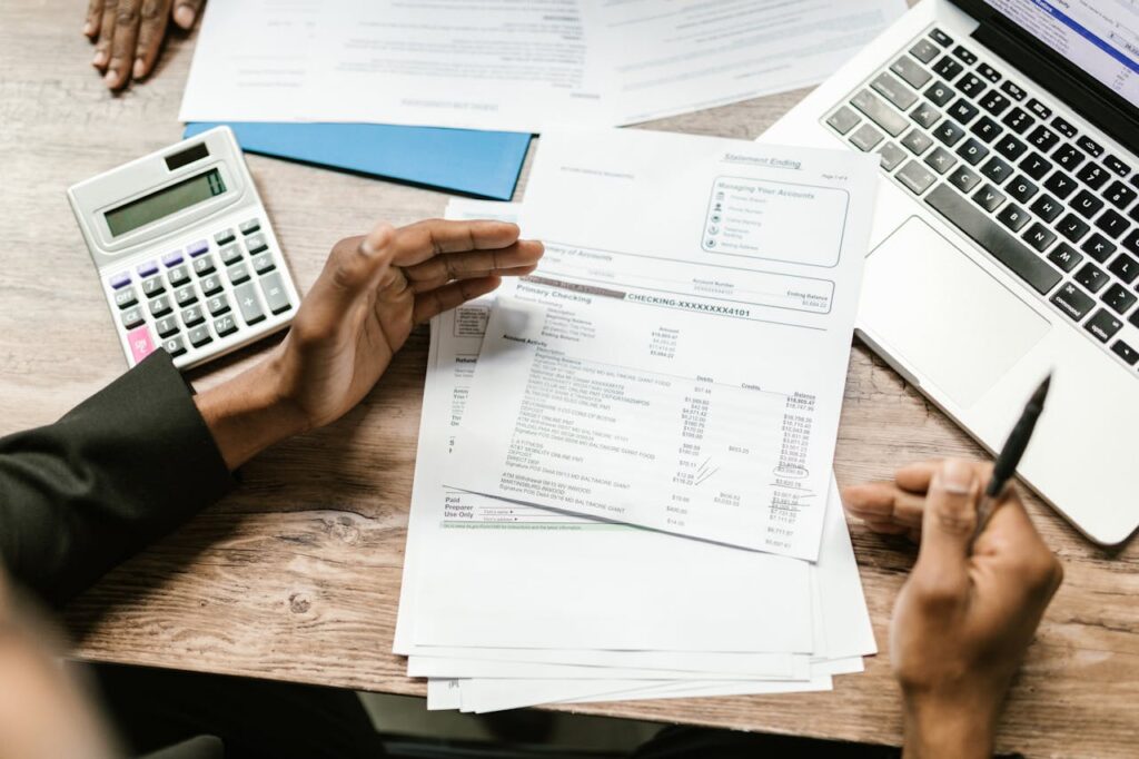 calculator, laptop and financial documents