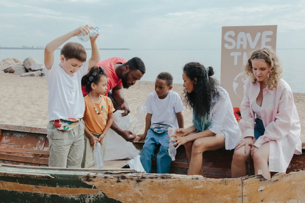 volunteers with children on a shore