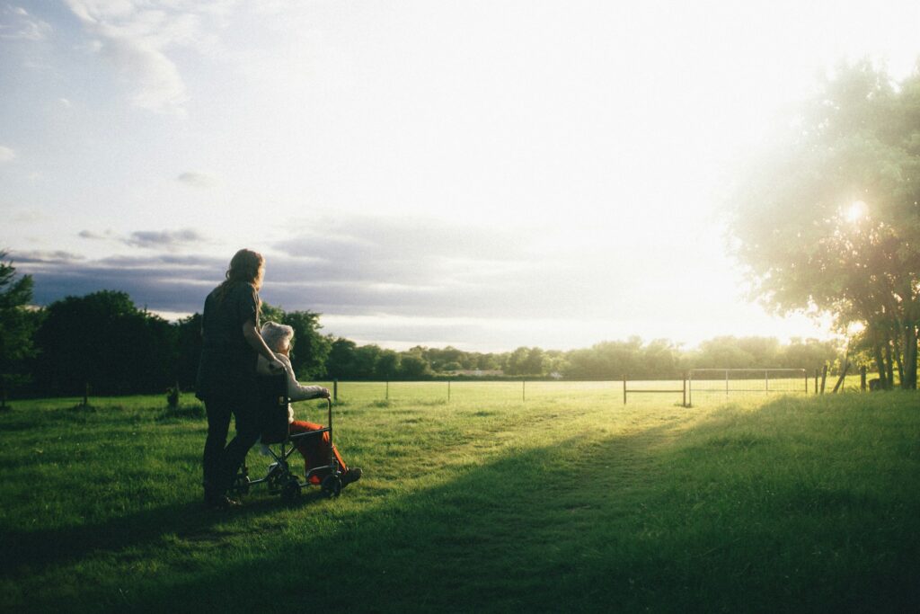 dominik-lange-VUOiQW4OeLI-unsplash person standing next to a person on wheelchair