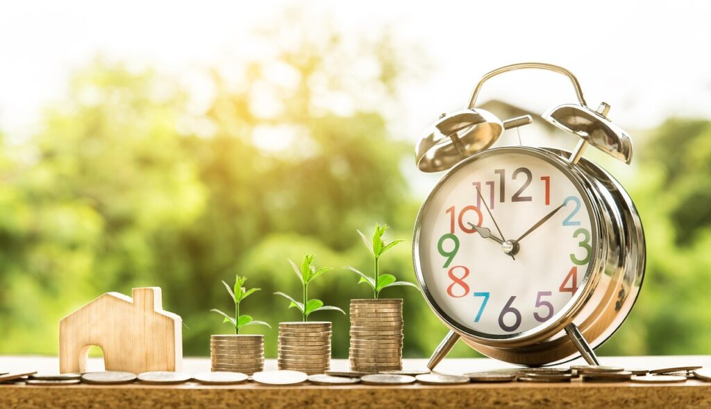 money-2696229_1280 A miniature house beside cash and clock
