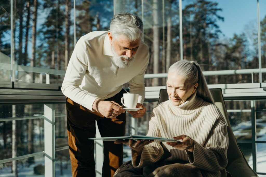 elderly couple having coffee and checking document