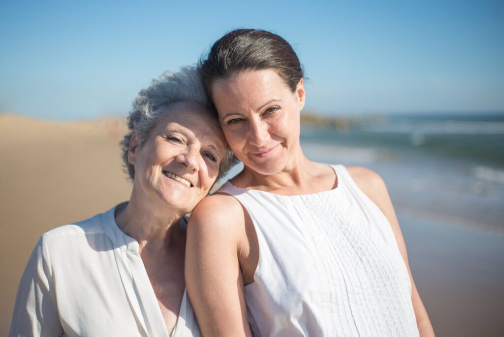 elderly woman and daughter on a beach