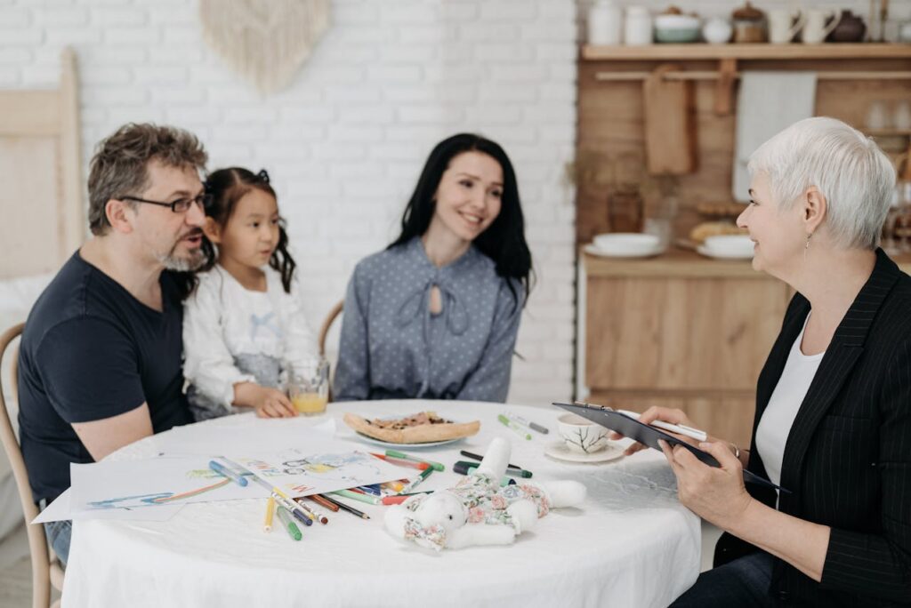 an elderly talking to a young family