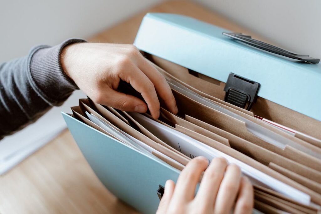 person looking for files in a document case