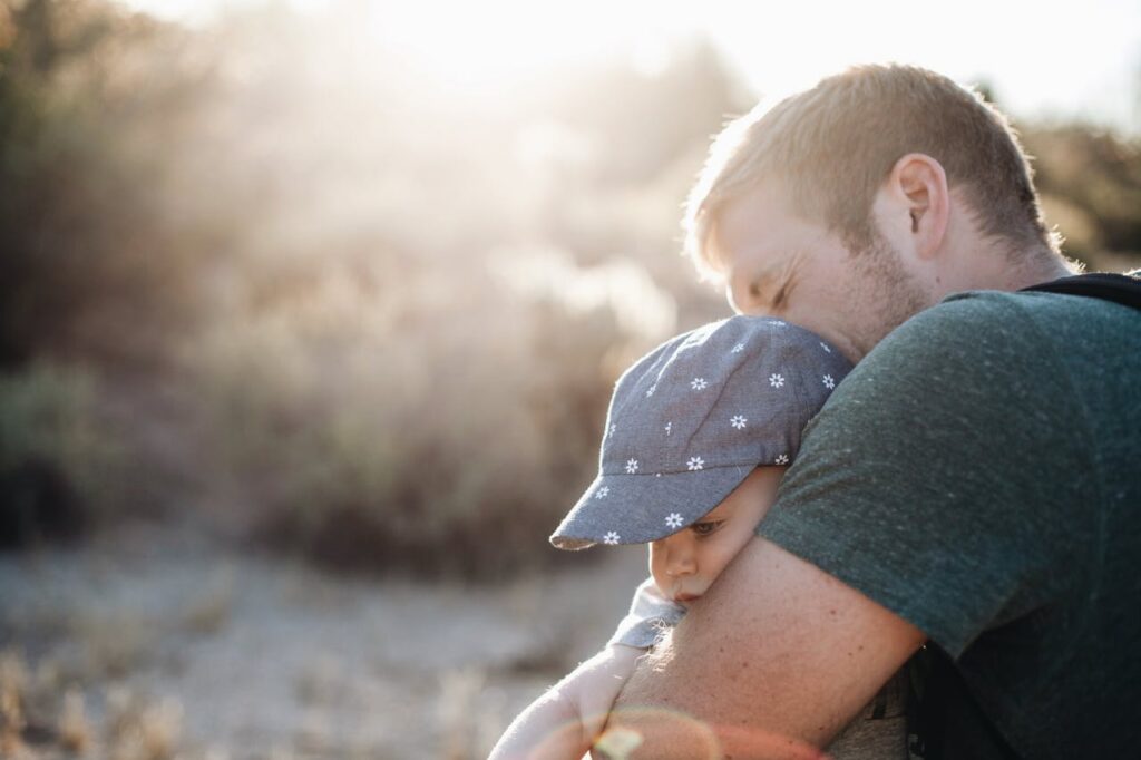 man hugging his son