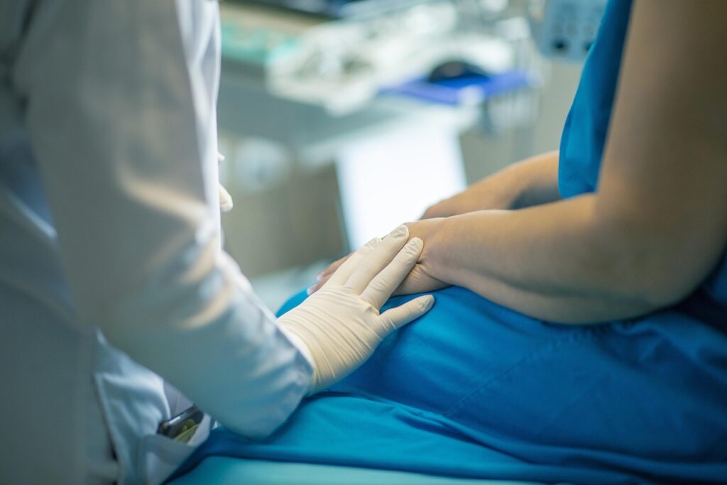 treatment-4099432_1280 A doctor's hand on a patient