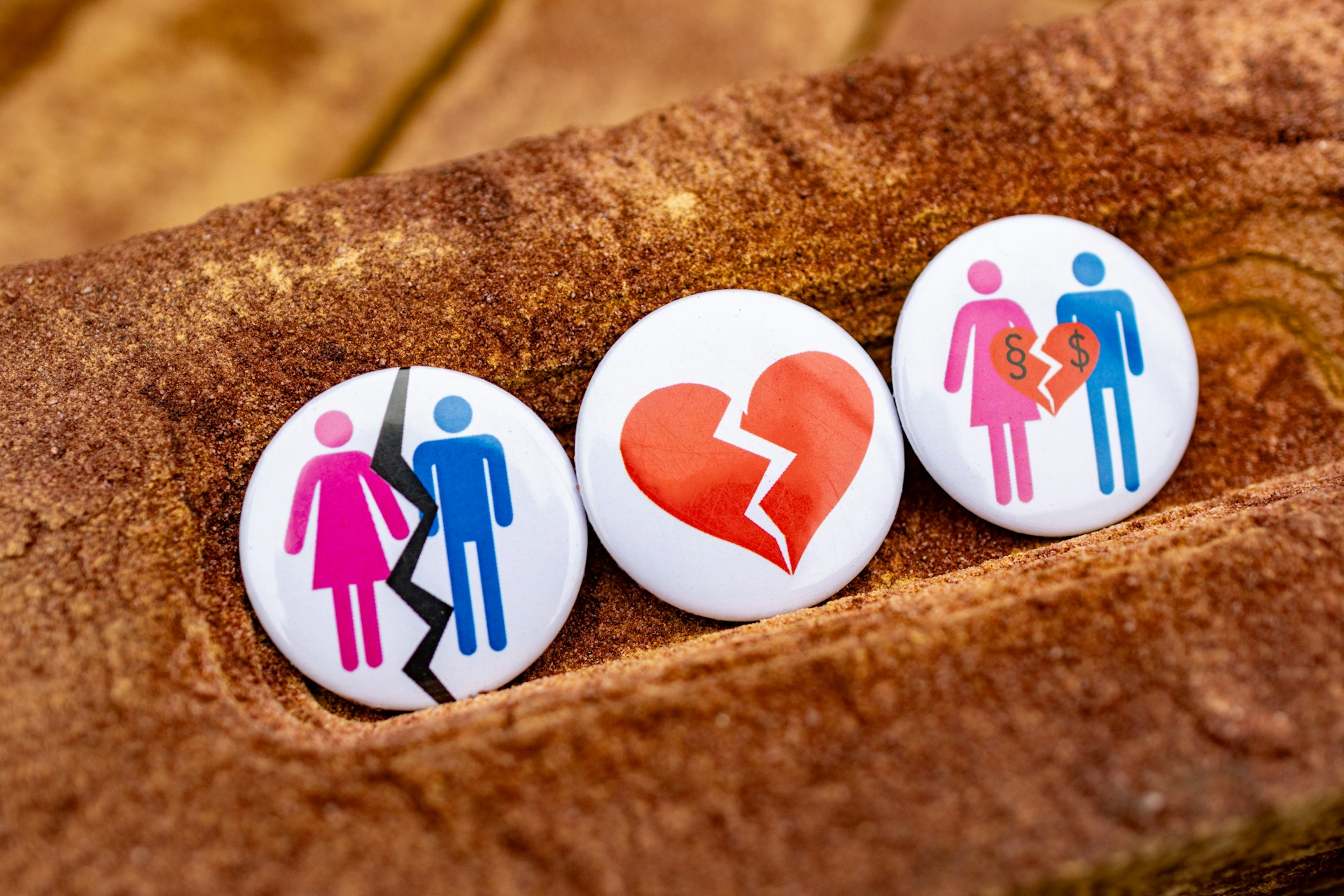 three buttons with people and a broken heart