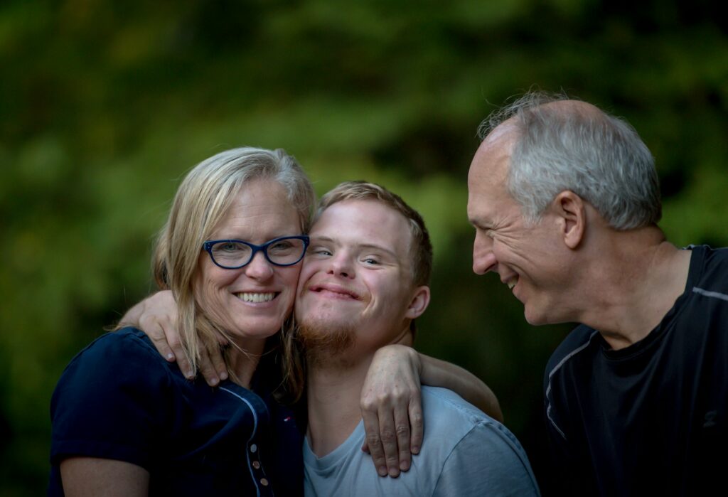 nathan-anderson-GM5Yn5XRVqA-unsplash a man and woman with a special needs child in between them