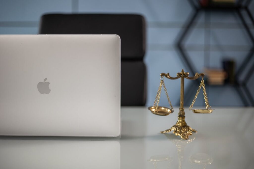 laptop beside scale of justice