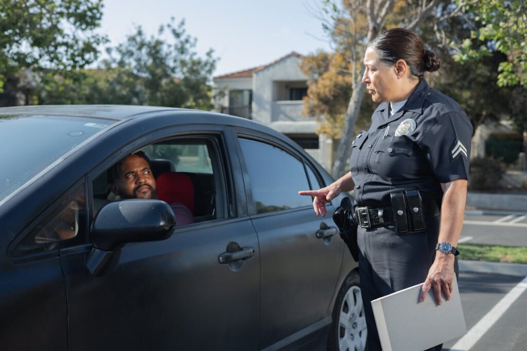 police talking to a man inside a car