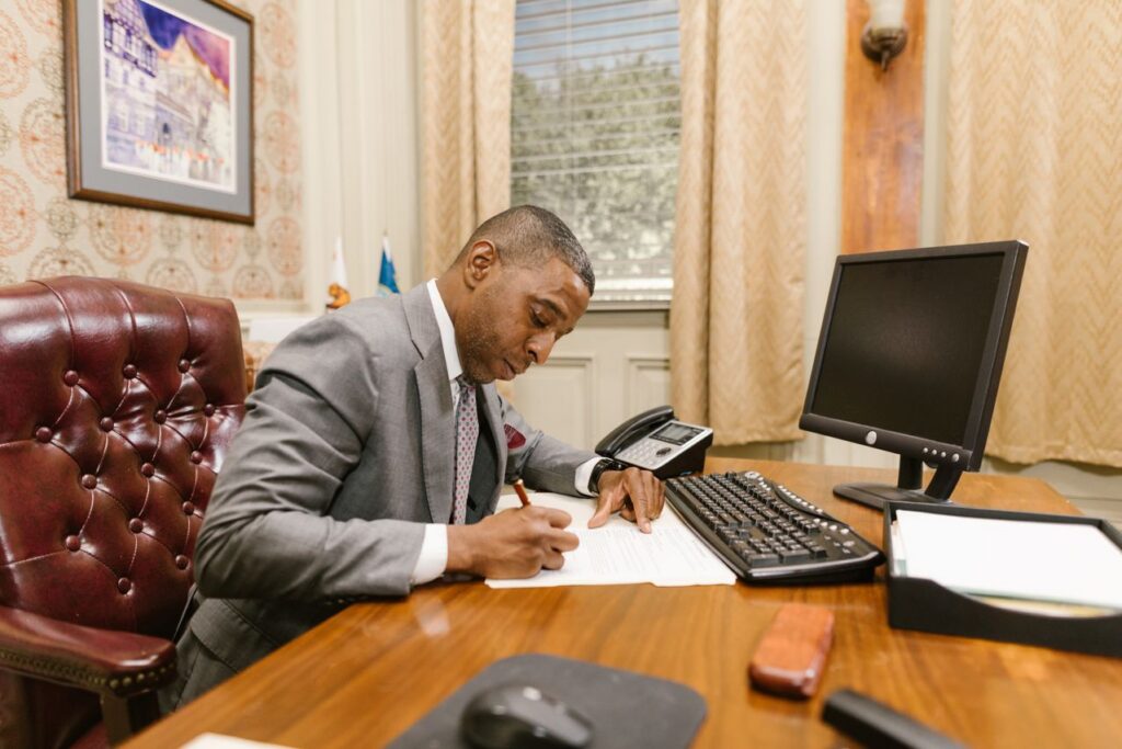 man in suit working at an office desk