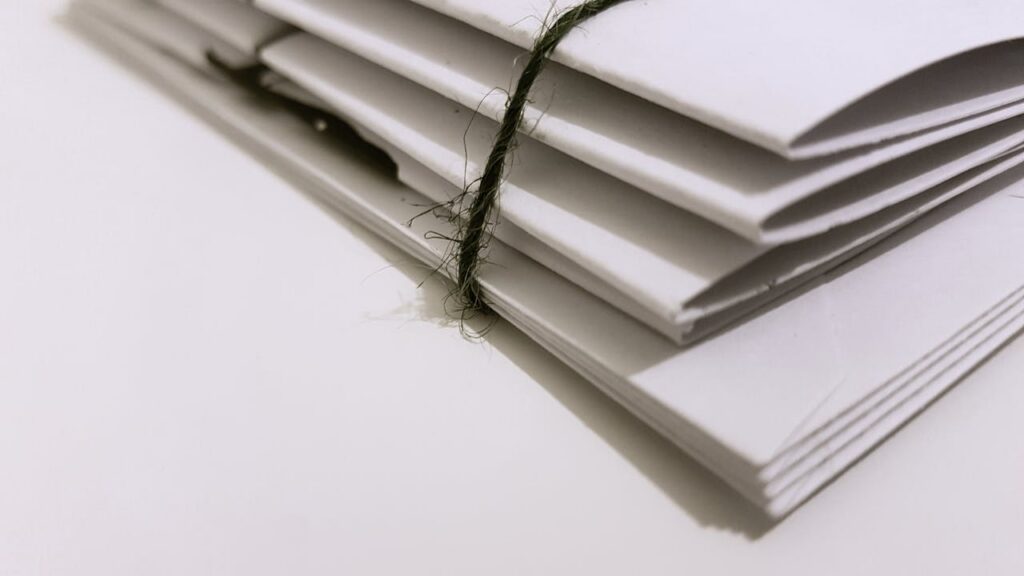 white folders tied up in black string