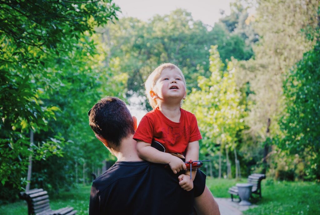 a man carrying a little boy