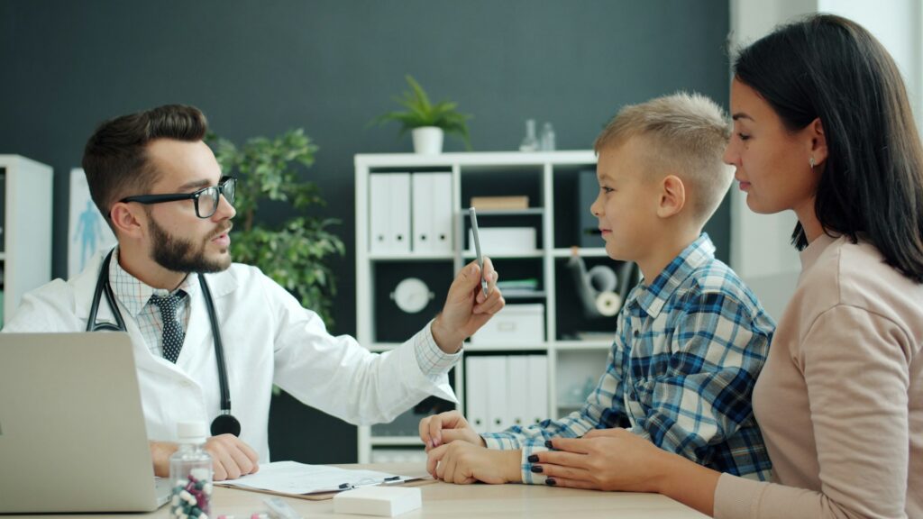 doctor examines a young boy