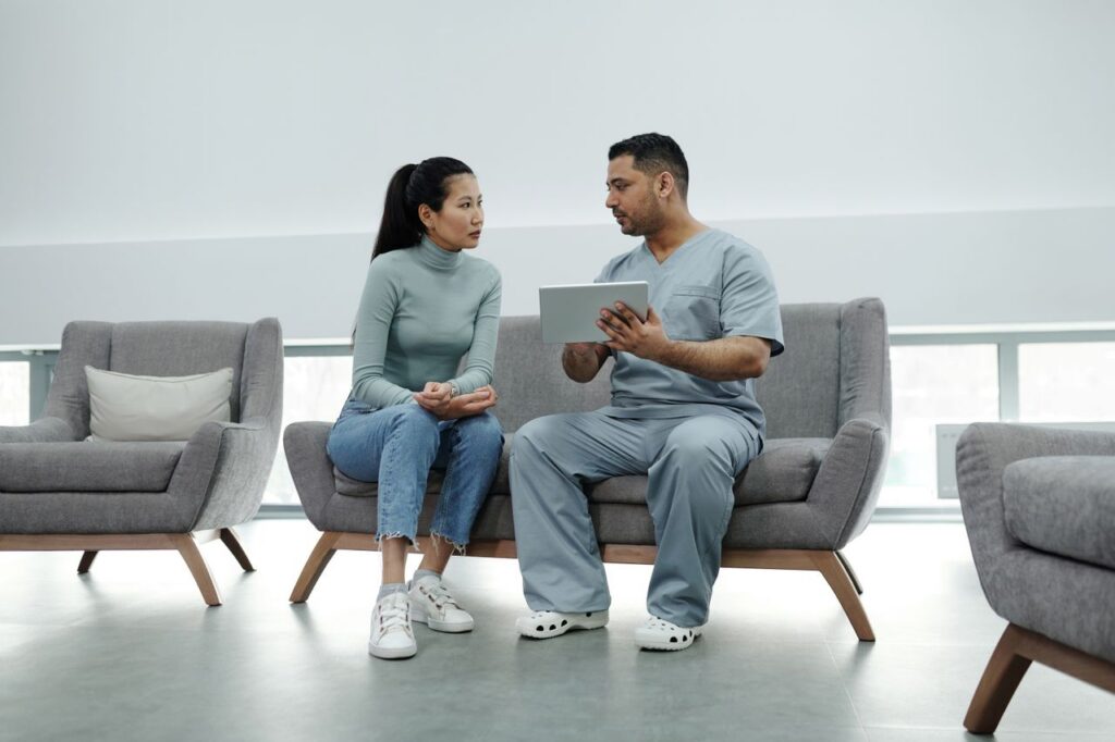 doctor showing tablet to a woman