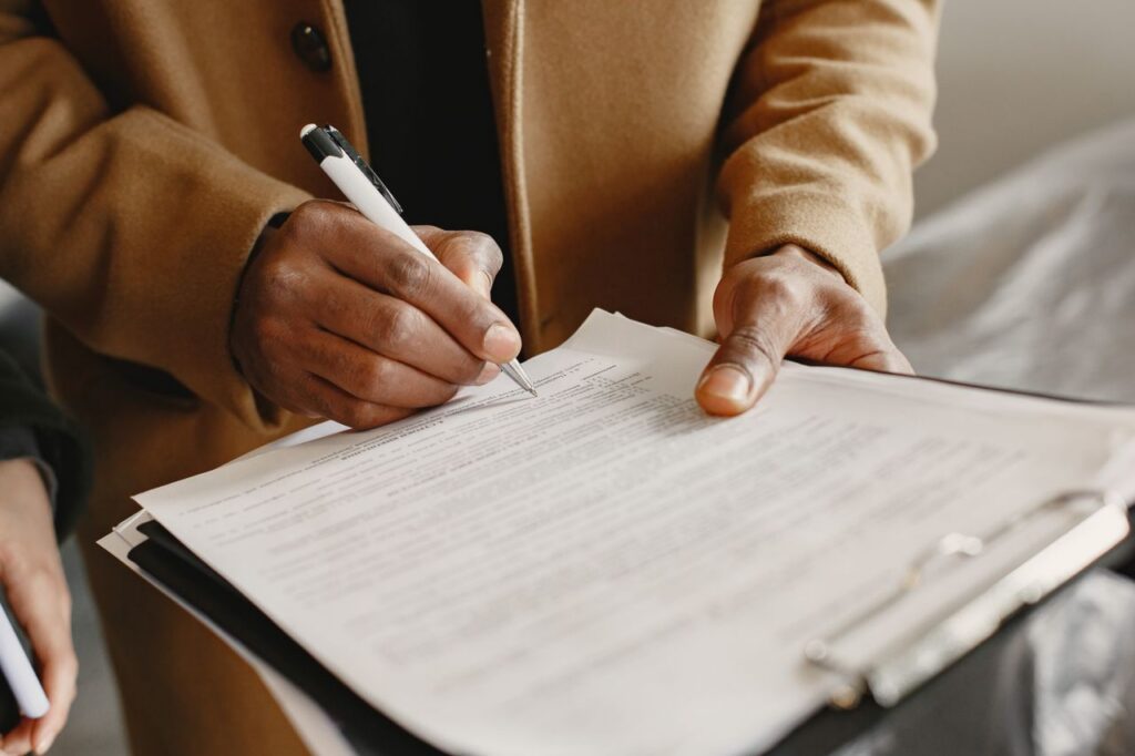 person signing a document