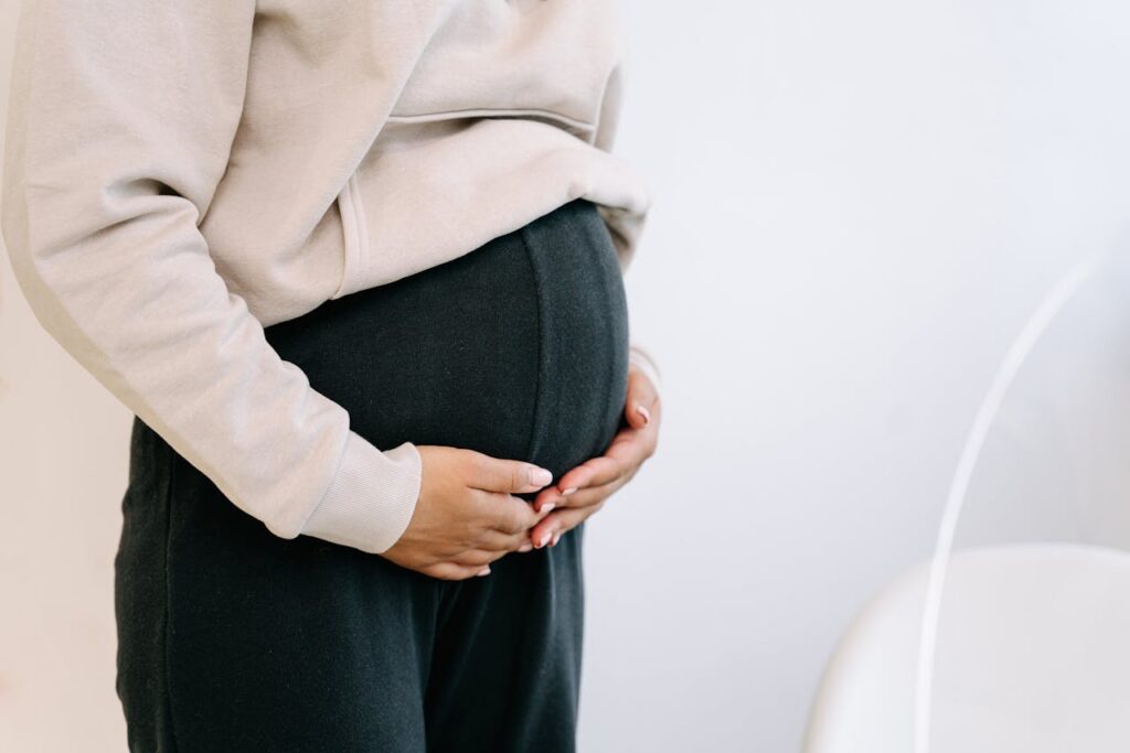 woman holding her pregnant belly