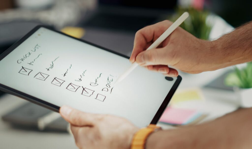 person ticking checklist boxes