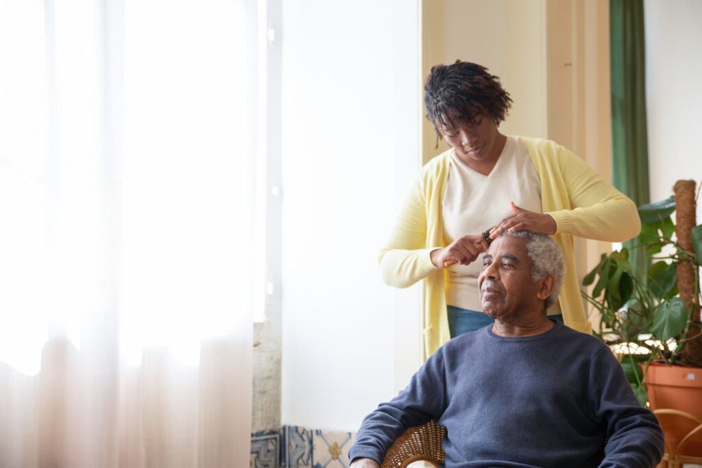 a woman combing an elderly person's hair