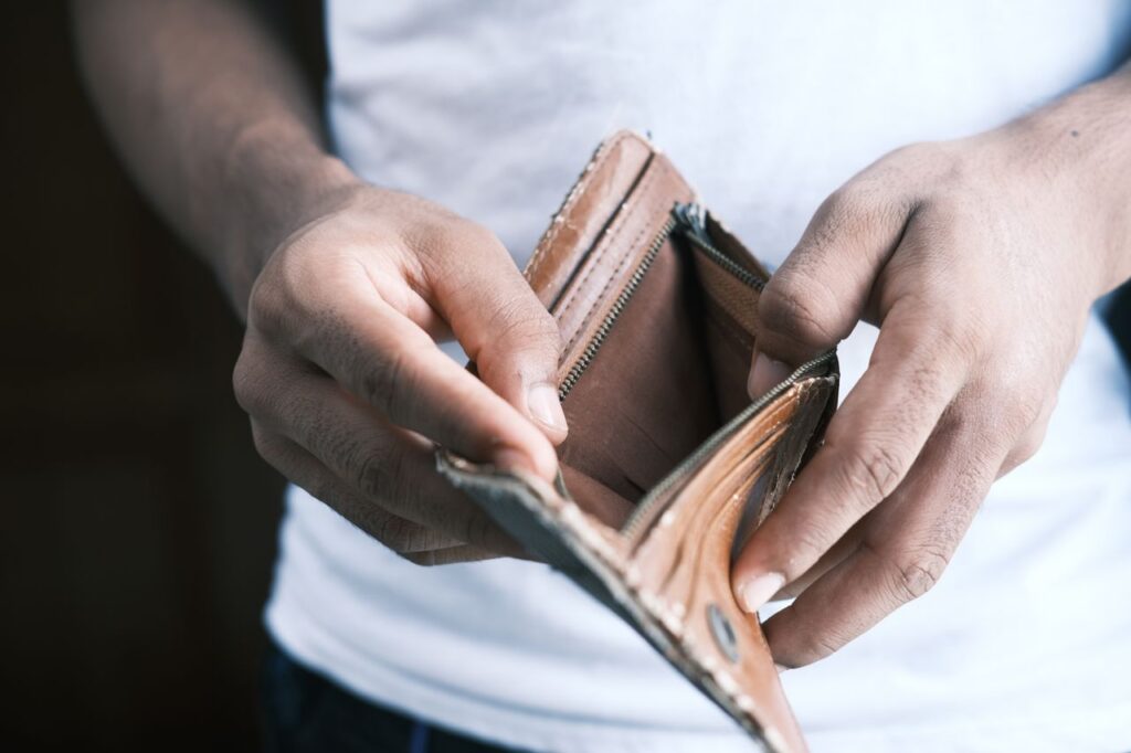 person looking at an empty wallet