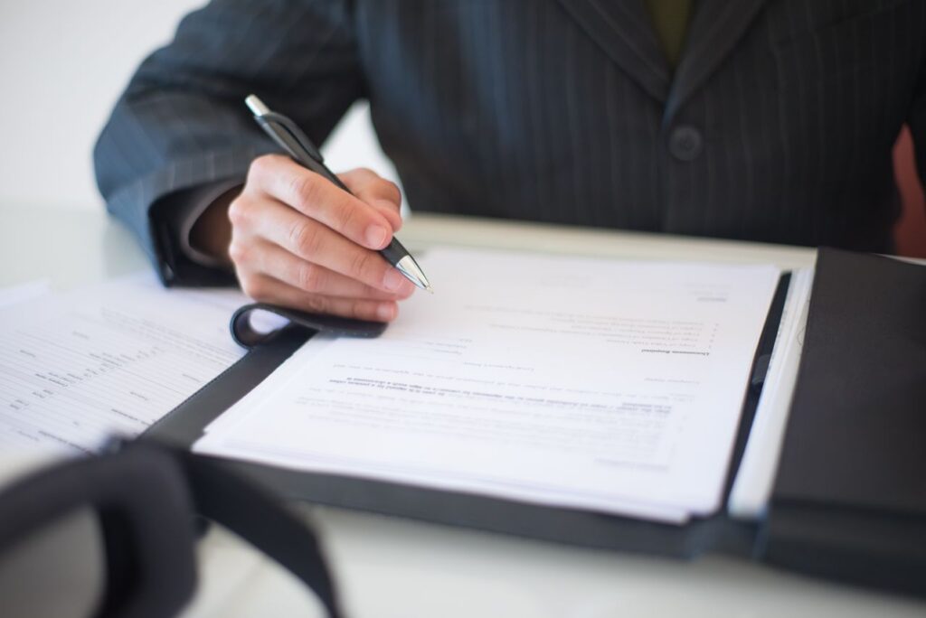 a person writing on a document