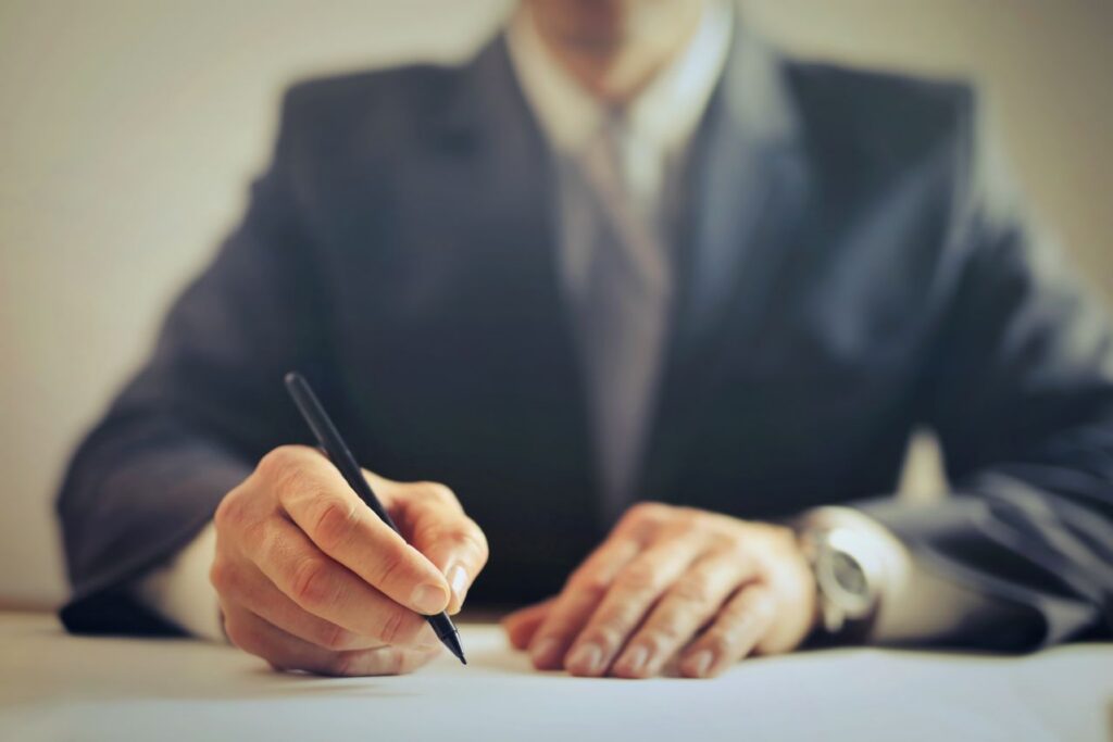 a person in suit writing