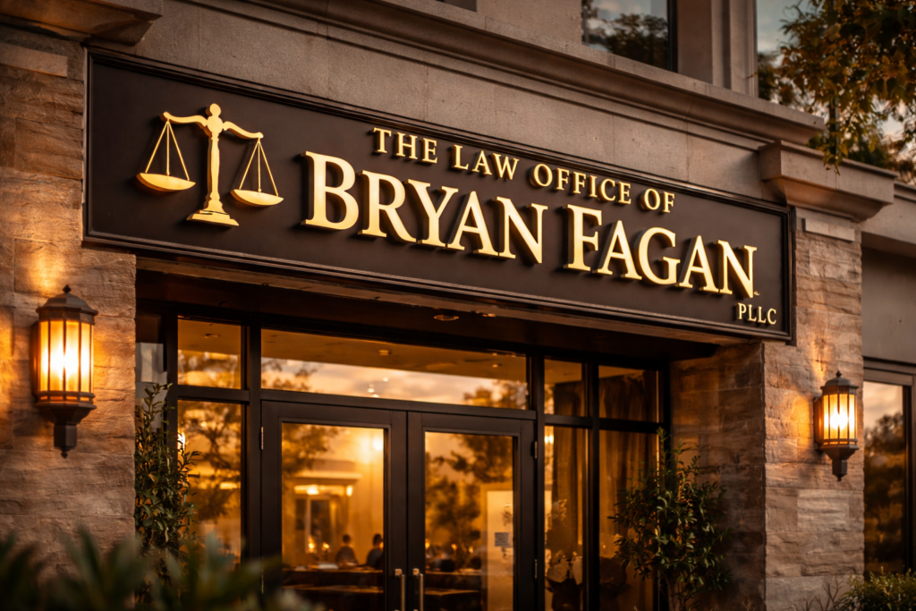 Exterior of The Law Office of Bryan Fagan, PLLC with illuminated signage and stone facade captured in warm evening light.