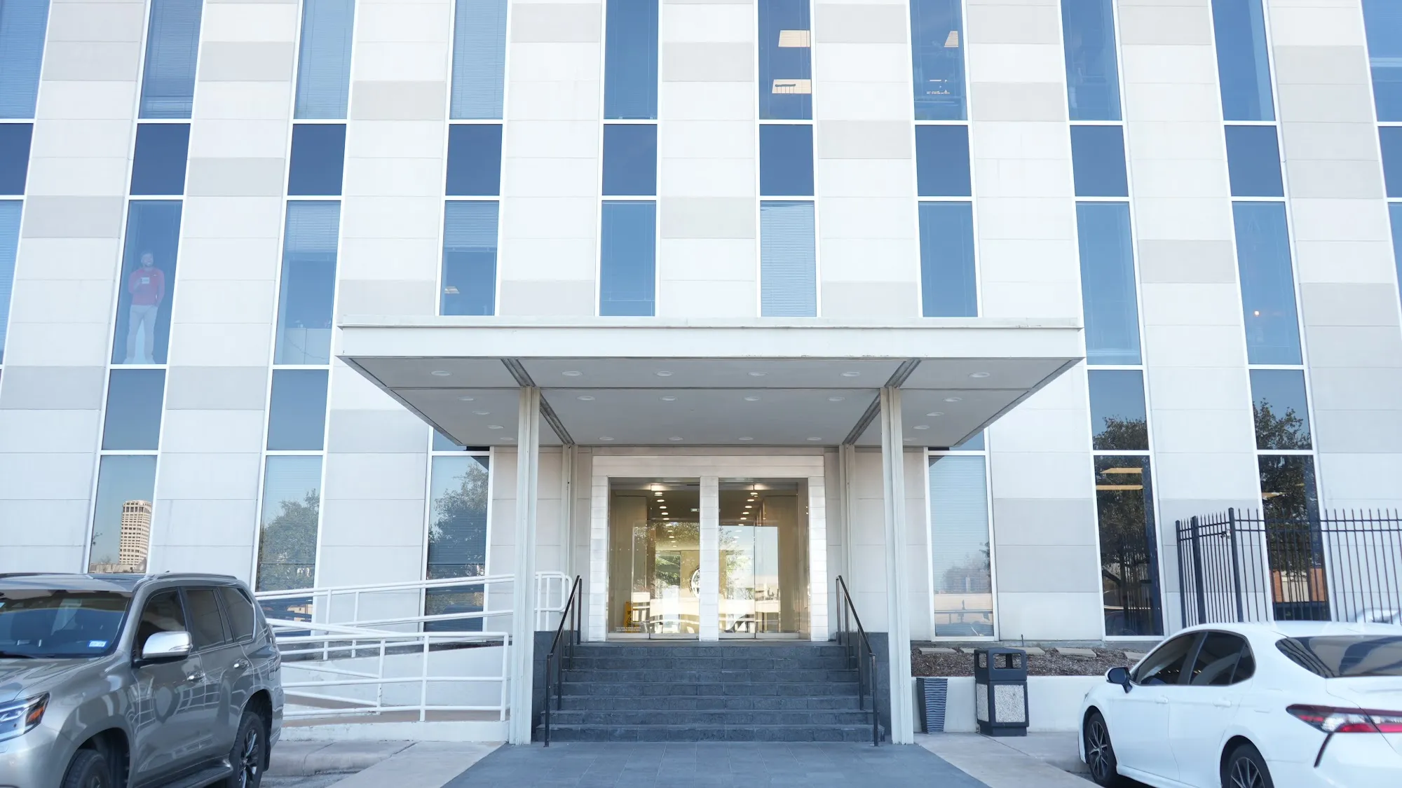 Glass entrance with covered awning at River Oaks virtual law office, Richmond Avenue Houston