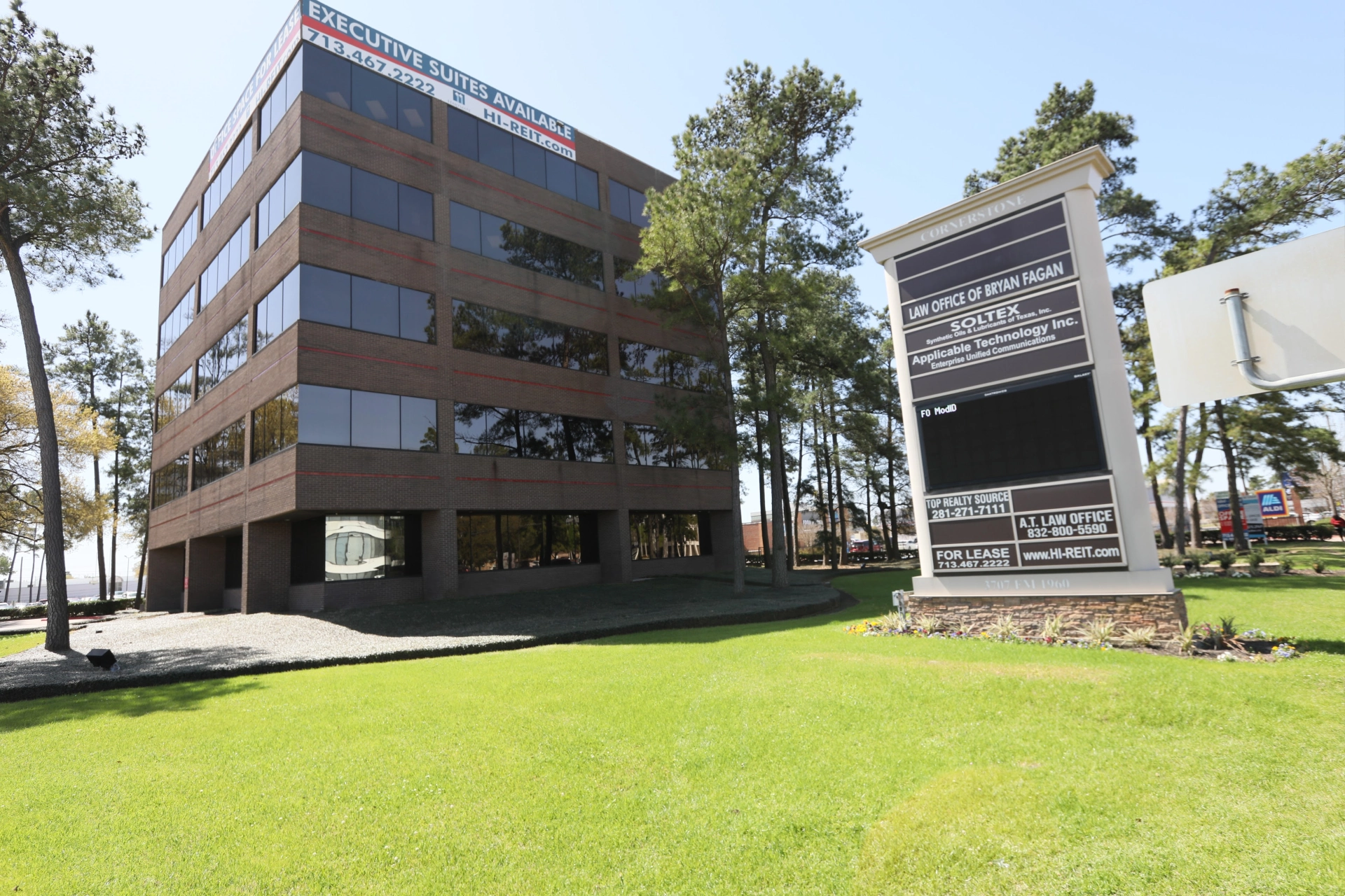 Houston office location exterior building with surrounding landscape and signage