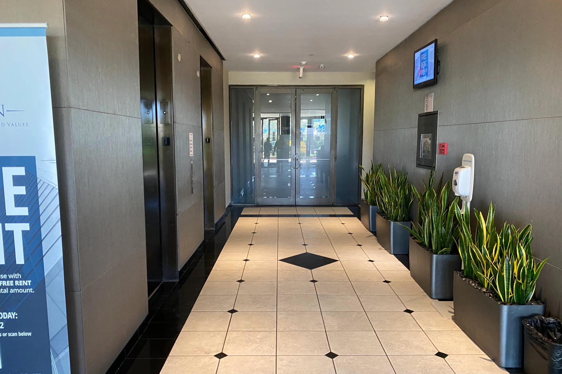 Office building entrance with glass doors and covered walkway